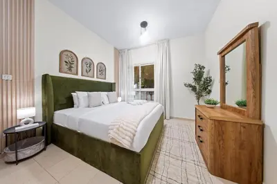 a bedroom with a large bed and a window at Surrounded by Nature Near Internet & Media City in Dubai