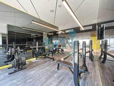 a gym with several treadmills and machines at Aspin 2BHK- Stay in the heart of Dubai- 45th floor in Dubai