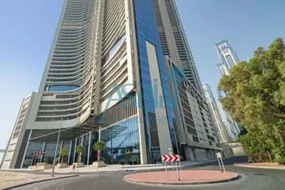 a large building with a stop sign in front of it at Aspin 2BHK- Stay in the heart of Dubai- 45th floor in Dubai