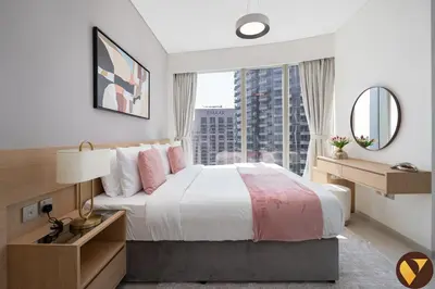 a bedroom with a large bed and a large window at Vogue Downtown Grande Signature Residences, near Dubai Mall and Burj Khalifa, Two-Bedroom Apartment with Large Balcony, Infinity Pool with Burj Khalifa View, Access to all Amenities in Dubai