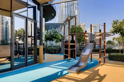a playground on a building with a view of the city at Vogue Downtown Grande Signature Residences, near Dubai Mall and Burj Khalifa, Two-Bedroom Apartment with Large Balcony, Infinity Pool with Burj Khalifa View, Access to all Amenities in Dubai