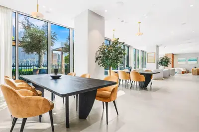 a dining room with a table and chairs at Vogue Downtown Grande Signature Residences, near Dubai Mall and Burj Khalifa, Two-Bedroom Apartment with Large Balcony, Infinity Pool with Burj Khalifa View, Access to all Amenities in Dubai