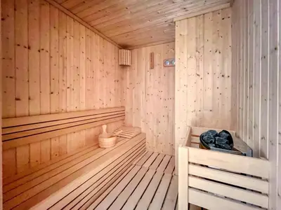 an empty wooden sauna with a bench in it at Azizi Riviera 63 in Dubai