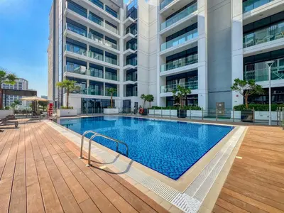 a swimming pool in front of a building at Azizi Riviera 63 in Dubai