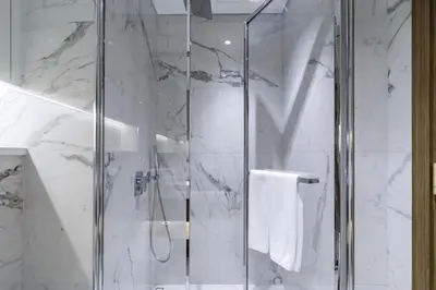 a bathroom with a shower with a glass door at Azizi Riviera 63 in Dubai