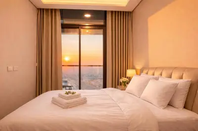 a bedroom with a large white bed with a window at DAMAC Maison AYKON City C 3 Bedrooms Walk to Metro Sleeps 8 in Dubai