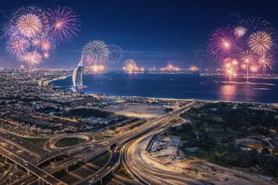 an aerial view of a city with fireworks at DAMAC Maison AYKON City C 3 Bedrooms Walk to Metro Sleeps 8 in Dubai