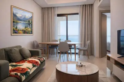 a living room with a couch and a table at DAMAC Maison AYKON City C 3 Bedrooms Walk to Metro Sleeps 8 in Dubai