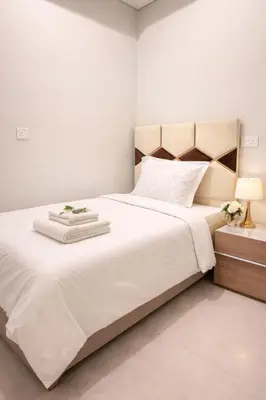 a bedroom with a large bed with white sheets at DAMAC Maison AYKON City C 3 Bedrooms Walk to Metro Sleeps 8 in Dubai