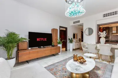 a living room with a flat screen tv on a entertainment center at Downtown Zaafaran 2, in Dubai