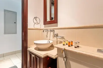 a bathroom with a sink and a mirror at Downtown Zaafaran 2, in Dubai