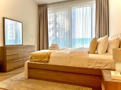 a bedroom with a large bed and a large window at Skyline 22 1 Residence in Dubai