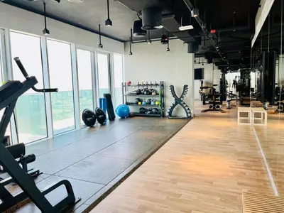 a gym with dumbbells and weights in a room with windows at Skyline 22 1 Residence in Dubai