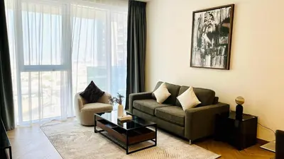 a living room with a couch and a coffee table at Skyline 22 1 Residence in Dubai