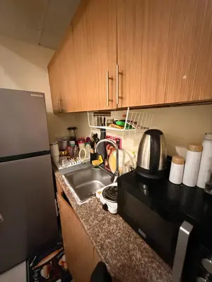 a kitchen with a sink and a microwave at ShortStayDubai in Dubai