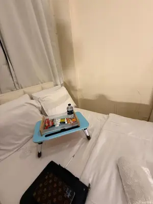 a tray of food on top of a bed at ShortStayDubai in Dubai
