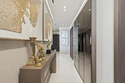 a hallway with a table with vases on it at Balcony with Majestic Sea and Palm View with Assistant Room, Private Beach Access, Minutes from Marina and Palm Jumeirah Destinations, Emaar Beachfront by Deluxe Holiday Homes in Dubai