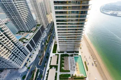 an aerial view of a city with tall buildings and a beach at Balcony with Majestic Sea and Palm View with Assistant Room, Private Beach Access, Minutes from Marina and Palm Jumeirah Destinations, Emaar Beachfront by Deluxe Holiday Homes in Dubai