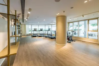 a gym with a row of treadmills and ellipticals at Balcony with Majestic Sea and Palm View with Assistant Room, Private Beach Access, Minutes from Marina and Palm Jumeirah Destinations, Emaar Beachfront by Deluxe Holiday Homes in Dubai