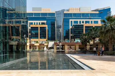 a fountain in the middle of a city with buildings at Frank Porter - Bay Square 1 in Dubai