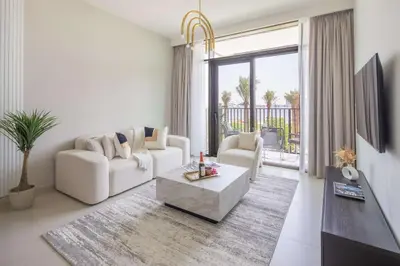 a living room with white furniture and a large window at Frank Porter - Creek Crescent Tower in Dubai