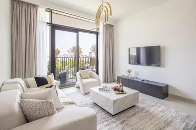 a living room with a couch and a tv at Frank Porter - Creek Crescent Tower in Dubai