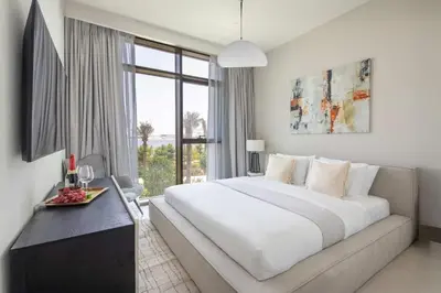 a bedroom with a large bed and a large window at Frank Porter - Creek Crescent Tower in Dubai