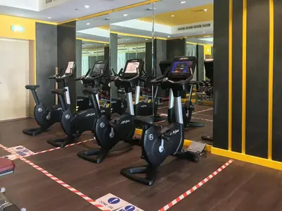 a gym with rows of cardio machines in a gym at Frank Porter - Merano Tower in Dubai