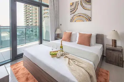 a bedroom with two beds and a large window at Frank Porter - Merano Tower in Dubai