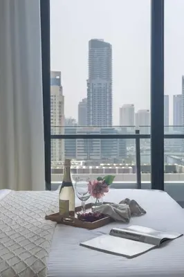 a table with a bottle of wine and a glass at Frank Porter - Silverene Towers A in Dubai