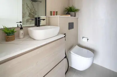 a bathroom with a sink and a toilet at Frank Porter - Silverene Towers A in Dubai