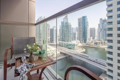a balcony with a table and a view of a city at Frank Porter - No, 9 Dubai Marina in Dubai