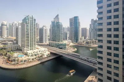 a bridge over a river in a city with tall buildings at Frank Porter - No, 9 Dubai Marina in Dubai