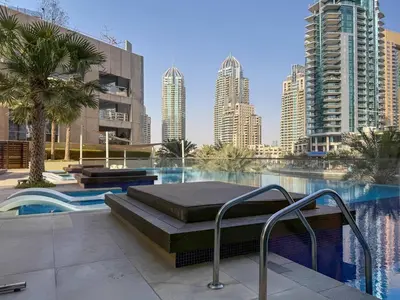 a swimming pool with a bed in the middle of a city at Frank Porter - No, 9 Dubai Marina in Dubai