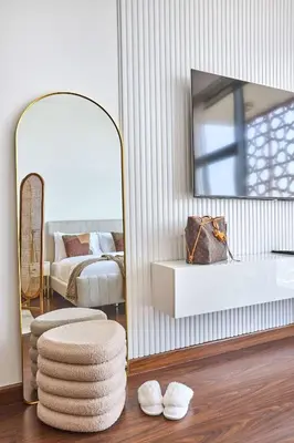 a living room with a mirror and a bed at Frank Porter - National Bonds Residence in Dubai