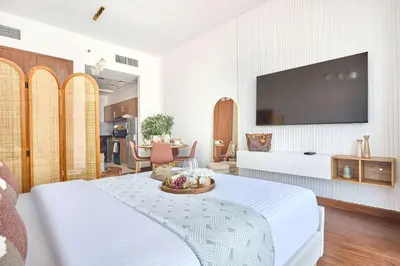 a hotel room with a bed and a flat screen tv at Frank Porter - National Bonds Residence in Dubai