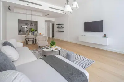 a white living room with a couch and a table at Frank Porter - Bay Square 1 in Dubai