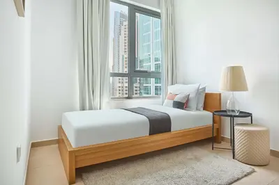 a bedroom with a bed and a large window at Frank Porter - Residences Tower 1 in Dubai