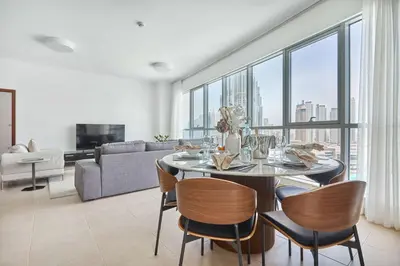 a living room with a table and chairs and a couch at Frank Porter - Residences Tower 1 in Dubai
