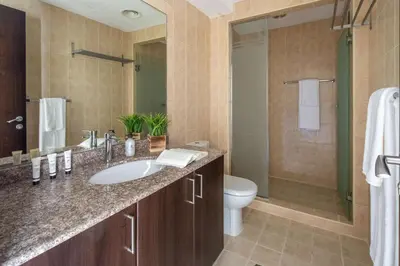 a bathroom with a sink and a toilet and a shower at Frank Porter - Churchill Residence Tower 2 in Dubai