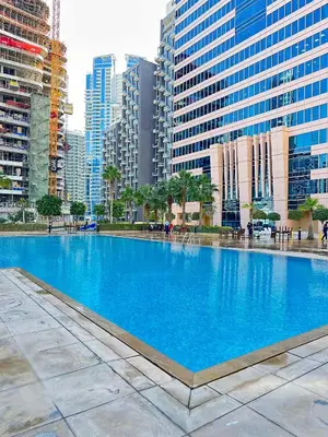 a large blue swimming pool in the middle of a city at Frank Porter - Churchill Residence Tower 2 in Dubai