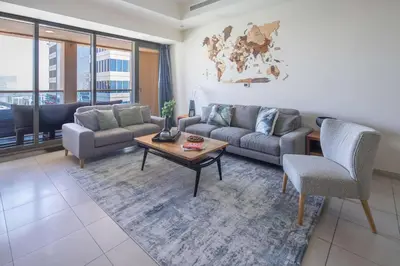a living room with a couch and a table at Frank Porter - Churchill Residence Tower 2 in Dubai
