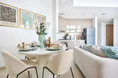 a kitchen and living room with a table and a couch at Frank Porter - Azizi Park Avenue in Dubai