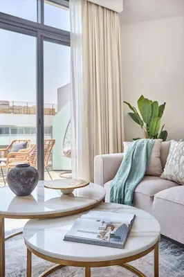a living room with a couch and a table at Frank Porter - Azizi Park Avenue in Dubai