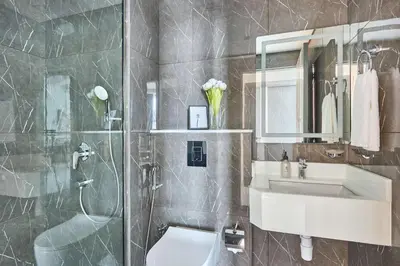 a bathroom with a toilet and a sink and a shower at Frank Porter - Samana Park Views in Dubai