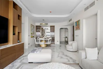 a living room with a couch and a table at Fairmont Residence Modern 2bhk in Palm Jumeirah in Dubai