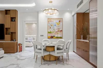 a dining room with a table and chairs at Fairmont Residence Modern 2bhk in Palm Jumeirah in Dubai