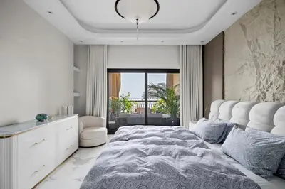 a bedroom with a large bed and a large window at Fairmont Residence Modern 2bhk in Palm Jumeirah in Dubai