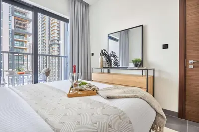 a bedroom with a large bed and a large window at Frank Porter - Sobha Hartland The Crest Tower C in Dubai