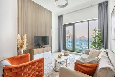 a living room with a couch and a tv at Frank Porter - The Bay in Dubai